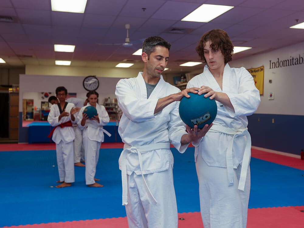 a group of people using a ball for taekwondo practice in Norristown PA