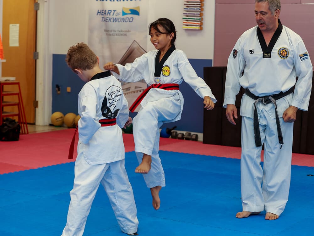 two young kids in taekwondo uniform doing a friendly spar in Norristown PA