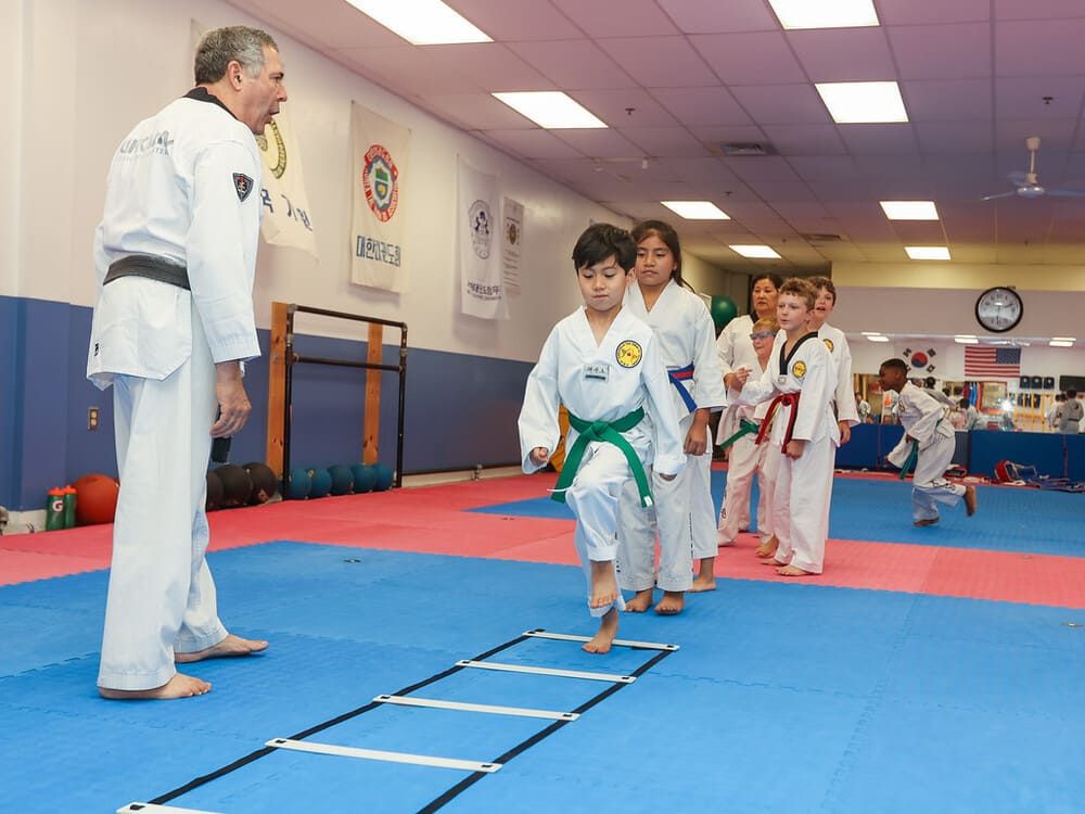 a taekwondo instrutor instruct his students in taekwondo class