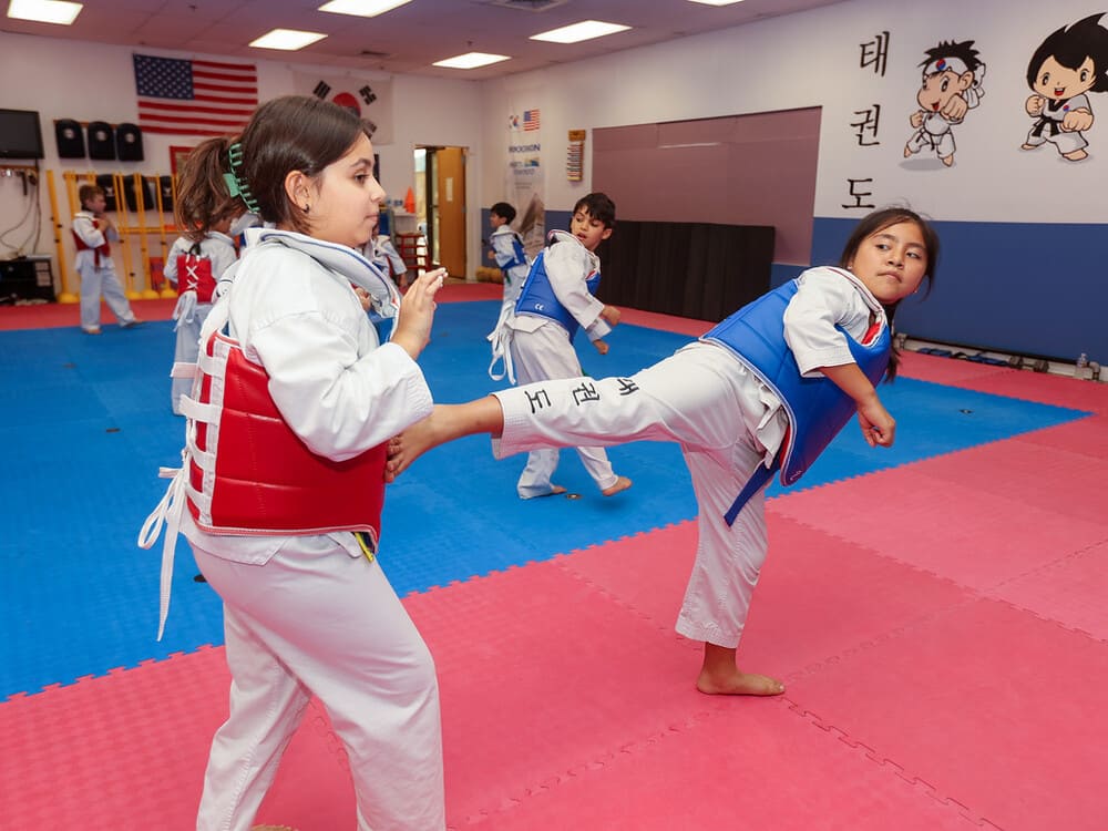 a group of kids pair for a taekwondo kicking practice in Norristown PA