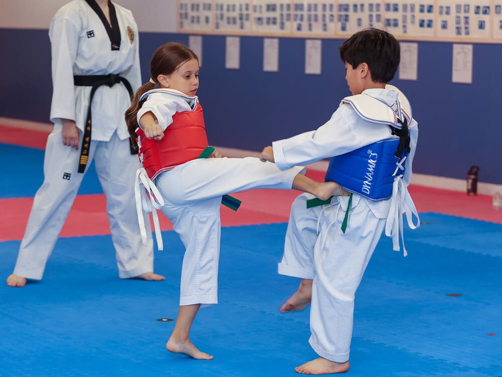 an asian boy and a white girl pair for a taekwondo kicking practice in Norristown PA