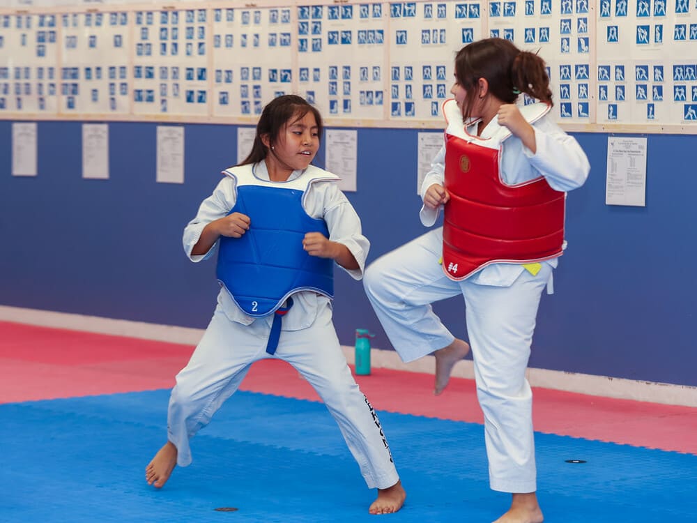 two young girls in taekwondo uniform pair for friendly spar in Norristown PA