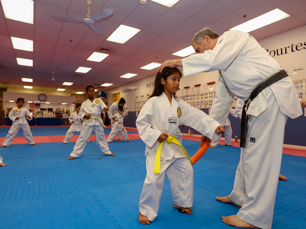 a group of kids practice taekwondo pose with their master in Norristown PA