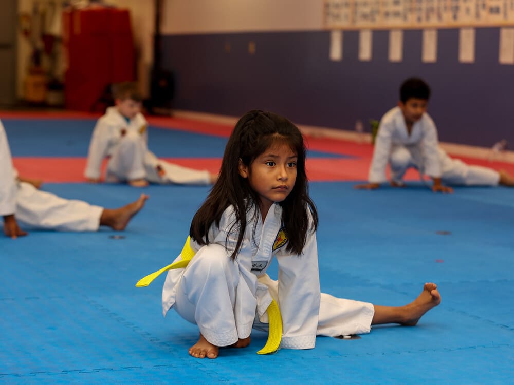 a group of kids in taekwondo uniform warm up before taekwondo class in Norristown PA